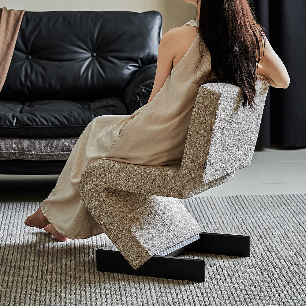 Woman sitting on a modern chair in a stylish living room.