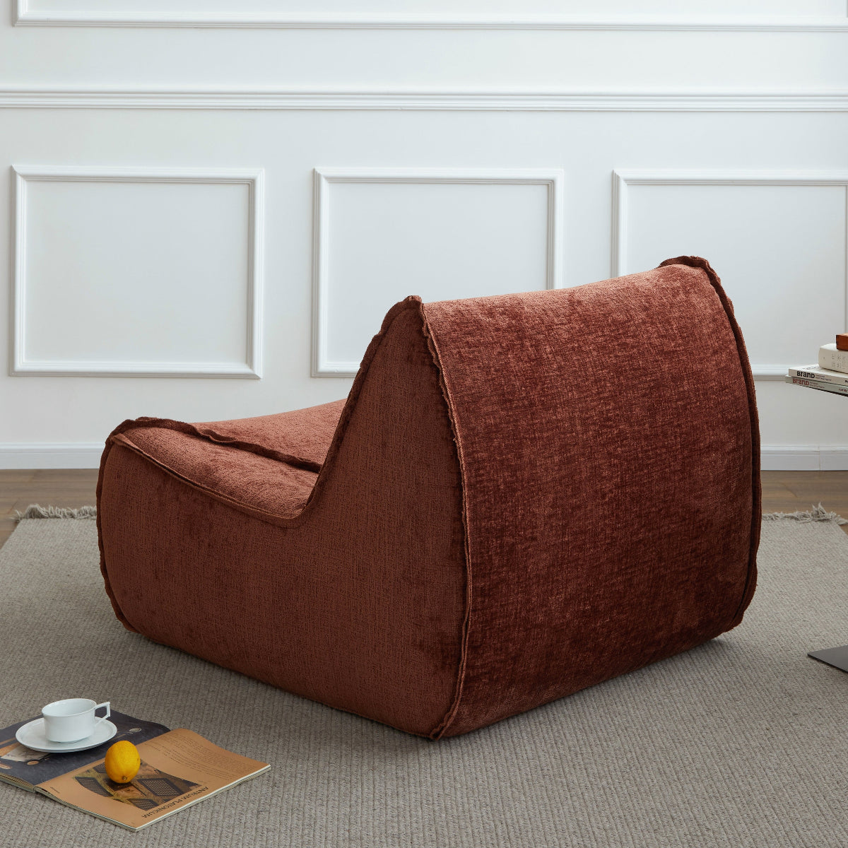 Brown pet bed on a gray carpet with a white wall in the background